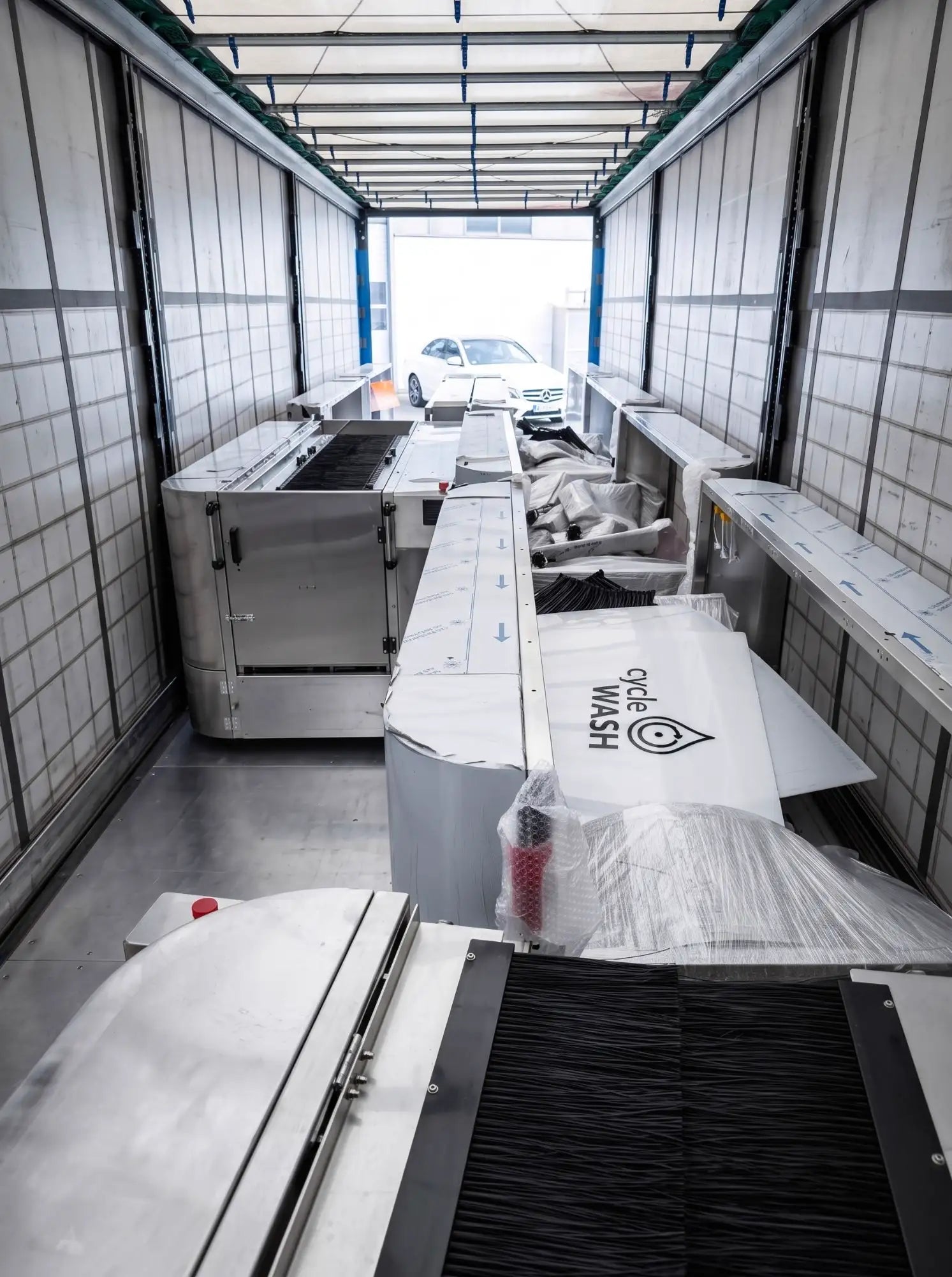 Inside a fully loaded trailer: machines, brush modules and ramps wrapped for transport