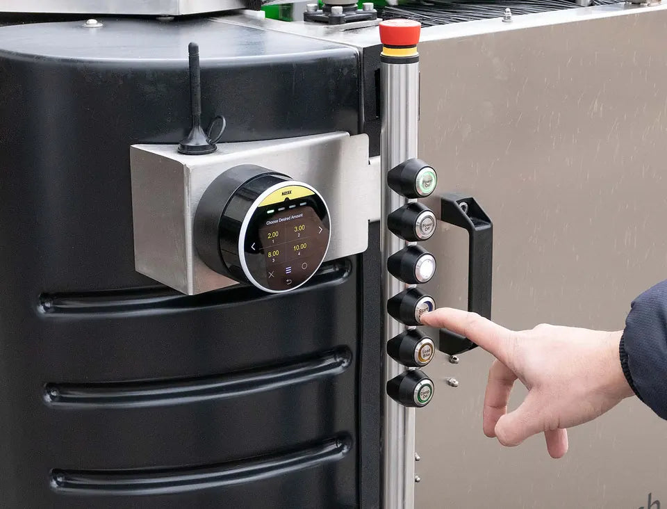 A hand pressing the programme buttons beside the reader