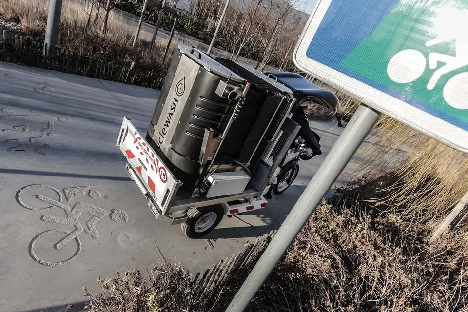The Go and its trailer parked beside a cycle route sign